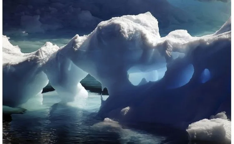 iceberg-arches-melting-into-freezing-blue-sea